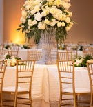 Large Display of Cream Flowers with Greenery
Photography: D2 Photography
Read More:
http://www.insideweddings.com/weddings/luxurious-italian-inspired-destination-wedding-in-las-vegas/1194/ large stone vase with ivory flowers and dark greenery in the center of intersecting tables with