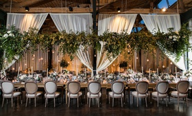 Suspended Greenery Above Table
Photography: Vue Photography
Read More:
http://www.insideweddings.com/weddings/rustic-elegant-wedding-full-of-flowers-and-greenery-in-atlanta/1133/ greenery displayed above king's table at wedding reception, drapery