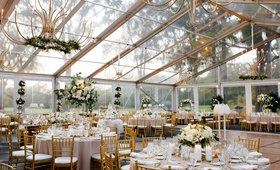 Clear Tent with White %26 Green Centerpieces
Photography: Studio This Is
Read More:
http://www.insideweddings.com/weddings/traditional-catholic-ceremony-classic-country-club-reception/1360/ wedding reception clear tent with gold chandelier greenery white flower centerpieces