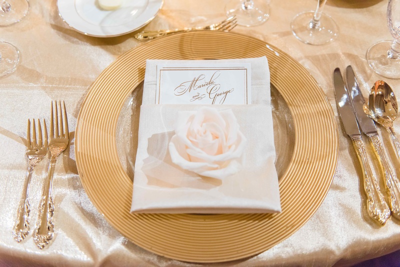 Gold Charger Plate %26 Flatware
Photography: The Yodsukars
Read More:
http://www.insideweddings.com/weddings/glam-10th-wedding-anniversary-party-vow-renewal-in-california/917/ Wedding guest place setting with gold charger gilt flatware silverware and single white rose on menu