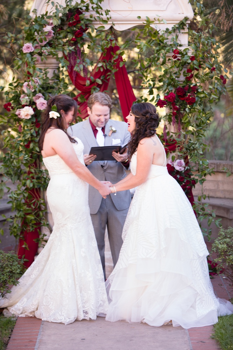 Brides Laugh During Vow Exchange
Photography: Acqua Photo
Read More:
http://www.insideweddings.com/weddings/balboa-park-wedding-with-wine-inspired-color-scheme-in-san-diego/948/ same-sex wedding, two brides, winnie couture gown, hayley paige gown, laughing during ceremony