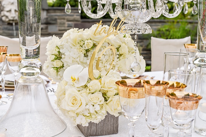 Laser Cut Table Number in Gold
Photography: Carasco Photography
Read More:
http://www.insideweddings.com/weddings/styled-shoot-combines-old-world-charm-and-contemporary-fashion/849/ gold laser cut table number placed in small, white floral arrangement of roses, hydrangeas, orchids