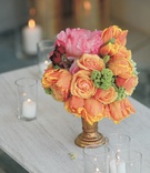 Floral Decor
Photography: Jay Lawrence Goldman Photography
Read More:
http://www.insideweddings.com/weddings/a-sophisticated-tented-estate-wedding-in-california/179/ Wedding reception floral arrangement of orange, pink, green, and red flowers in a gold vase