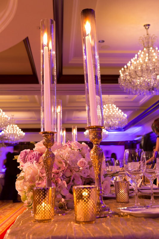 Regal Gold Candlesticks
Photography: Jay Lawrence Goldman Photography
Read More:
http://www.insideweddings.com/weddings/elegant-white-lavender-ballroom-wedding-with-cherry-blossom-trees/710/ Gold candle stick with taper candles in glass encasement and gold votives