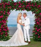 Bride %26 Groom at Acqualina Resort %26 Spa
Photography: Suzanne Delawar Studios
Read More:
http://www.insideweddings.com/weddings/intimate-oceanfront-wedding-with-romantic-red-pink-white-palette/1235/ bride in strapless wedding dress with groom in white suit pink shirt under greenery arch pink roses