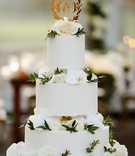 Three-Layer Cake with Gold Topper
Photography: Studio This Is
Read More:
http://www.insideweddings.com/weddings/traditional-catholic-ceremony-classic-country-club-reception/1360/ wedding cake round white tiers white orchid and rose flowers greenery gold laurel wreath cake topper