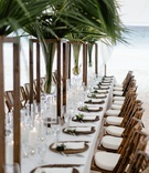 Tropical Reception Table on Beach
Photography: Grant Daniels Photography
Read More:
http://www.insideweddings.com/weddings/destination-wedding-with-tent-reception-on-the-beach-in-the-bahamas/1303/ wedding reception long white table palm tree centerpiece wood bamboo chairs ocean bahamas