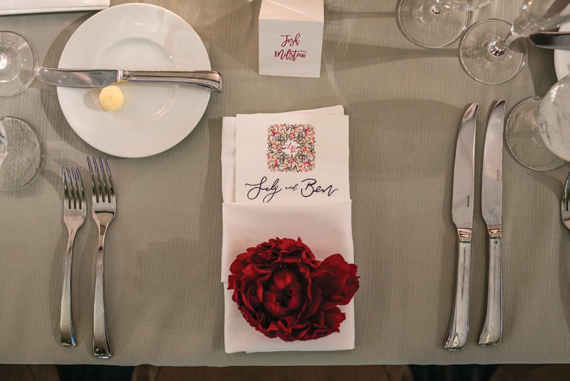 Red Peony at Place Setting
Photography: Kent Drake Photography
Read More:
http://www.insideweddings.com/weddings/bright-and-colorful-wedding-palette-with-ceremony-overlooking-lake/1315/ wedding place setting with red peony on napkin wrapped menu