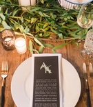 Black Menu Card with Monogram
Photography: Valorie Darling Photography
Read More:
http://www.insideweddings.com/weddings/real-wedding-with-rustic-organic-ambience-in-downtown-los-angeles/1094/ Wood table greenery with black menu card leaf monogram on top white plate wood table black gold fork