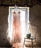 Gown with Blush Tint in Window
Photography: Mark Steines
Read More:
http://www.insideweddings.com/weddings/western-wedding-with-rustic-decor-at-the-oldest-barn-in-iowa/705/ Wedding dress in rustic window with embroidery and lace straps