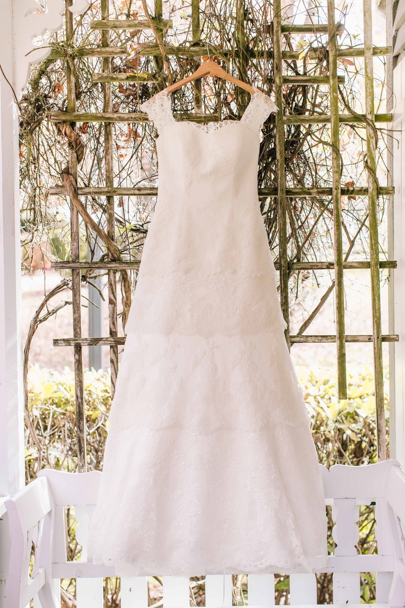 Tiered Wedding Dress on Hanger
Photography: Vue Photography
Read More:
http://www.insideweddings.com/weddings/baroque-autumn-wedding-with-deep-wine-tones-in-north-carolina/770/ a beautiful lace wedding dress with four tiers and straps hangs up