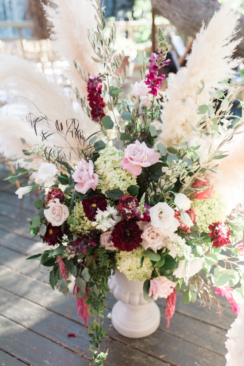 ceremony décor photos pampas grass and wine hued florals inside