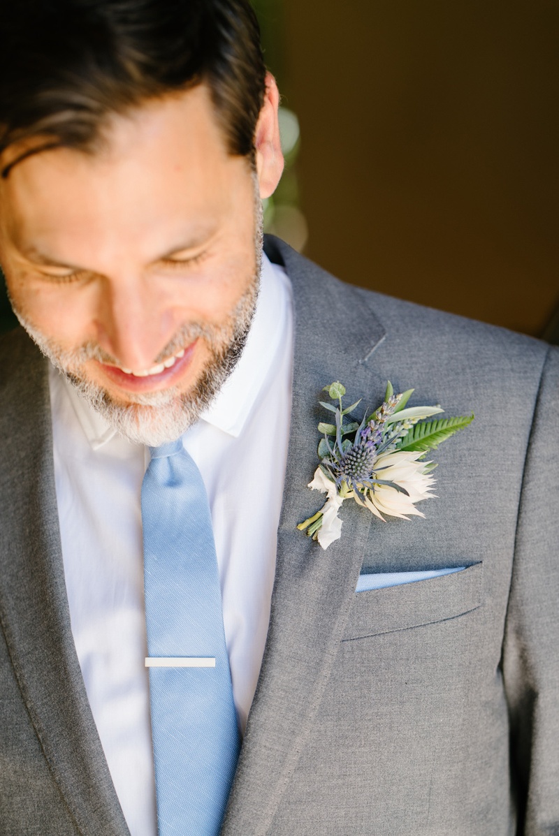 Groom with Wildflower Boutonniere
Photography: Karlisch Photography
Read More:
http://www.insideweddings.com/weddings/modern-rustic-wedding-full-of-flowers-and-geometric-details/906/ groom in grey suit and light blue tie, wildflower boutonniere