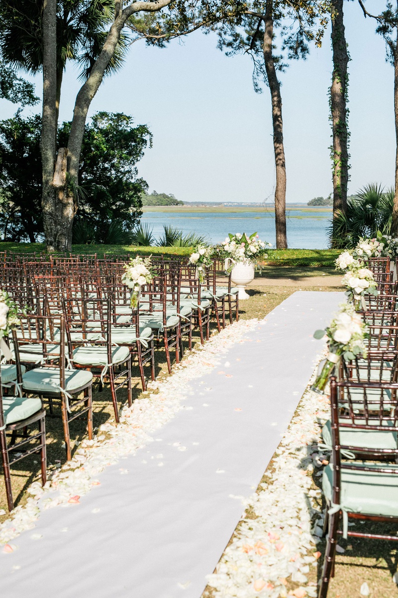 Waterfront Outdoor Wedding Ceremony
Photography: Vitor Lindo Photo + Video
Read More:
http://www.insideweddings.com/weddings/soft-romantic-spring-destination-wedding-in-south-carolina/1285/ the original runner company white non slip aisle runner white pink flower petals brown chairs mint
