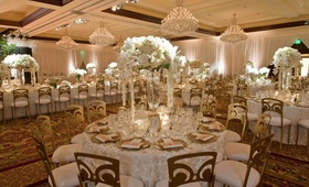 Ballroom Reception Space
Photography: John Solano Photography
Read More:
http://www.insideweddings.com/weddings/luxurious-traditional-wedding-at-four-seasons-westlake-village/374/ White rosette tablecloths and gold chairs
