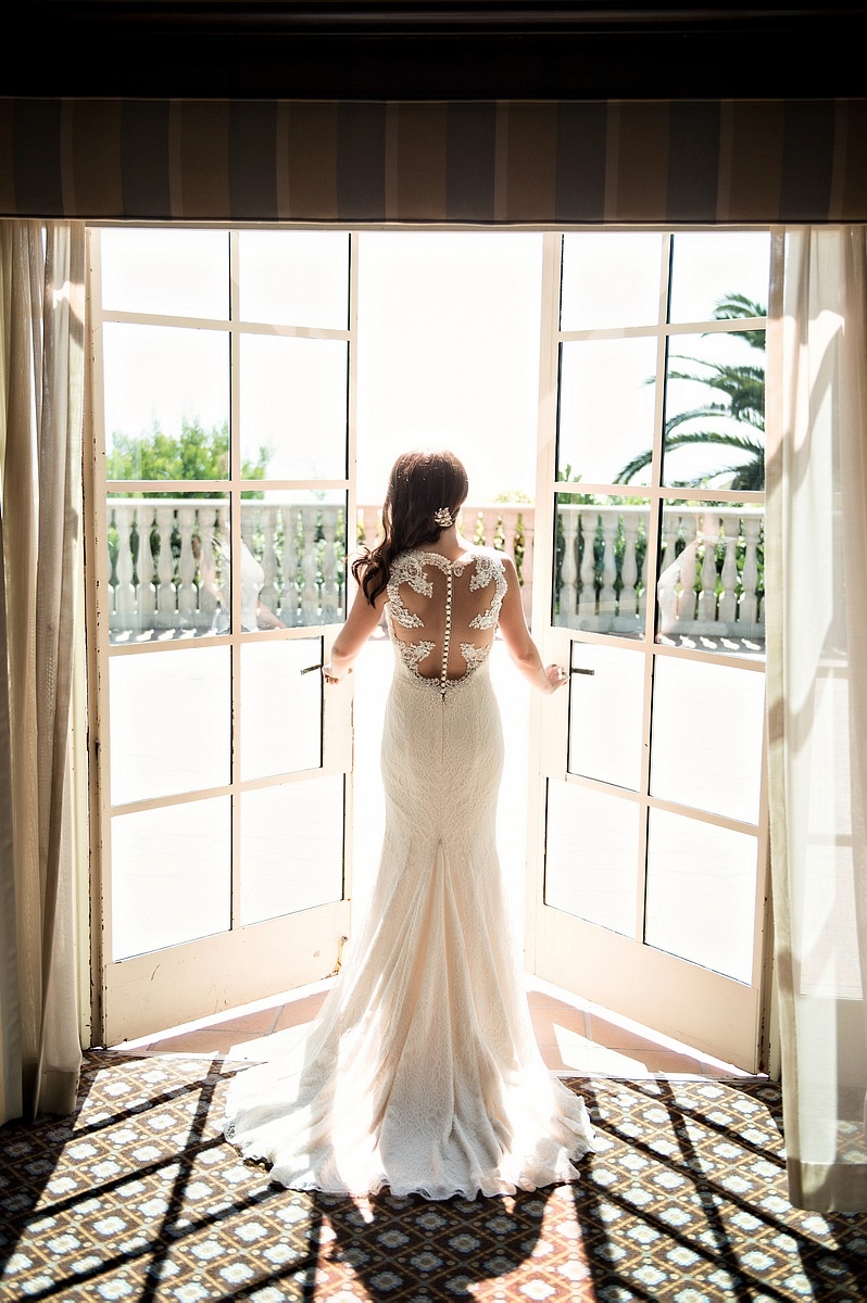 Bride Opening Double Doors to Balcony
Photography: Laurie Bailey Photography
Read More:
http://www.insideweddings.com/weddings/oceanfront-wedding-ceremony-classic-romantic-ballroom-reception/854/ bride open double doors oceanside balcony overlooking wedding space illusion back sheath gown