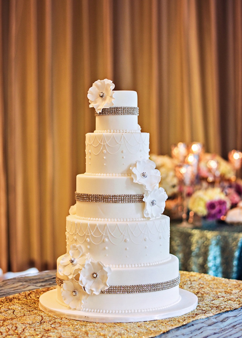 White Cake with Crystal Bands
Photography: Carasco Photography
Read More:
http://www.insideweddings.com/weddings/a-regal-modern-ethereal-inspirational-wedding-shoot-in-chicago/667/ Five layer white wedding cake with rhinestones and flowers
