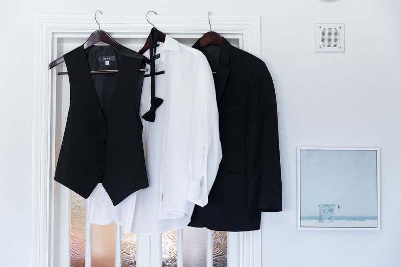 Groom's Attire Hanging in Suite
Photography: Maya Myers Photography
Read More:
http://www.insideweddings.com/weddings/ballroom-wedding-at-an-ocean-view-hotel-in-santa-monica-california/1325/ wedding attire for groom on hangers in groom's suite casa del bar black tuxedo vest bow tie shirt