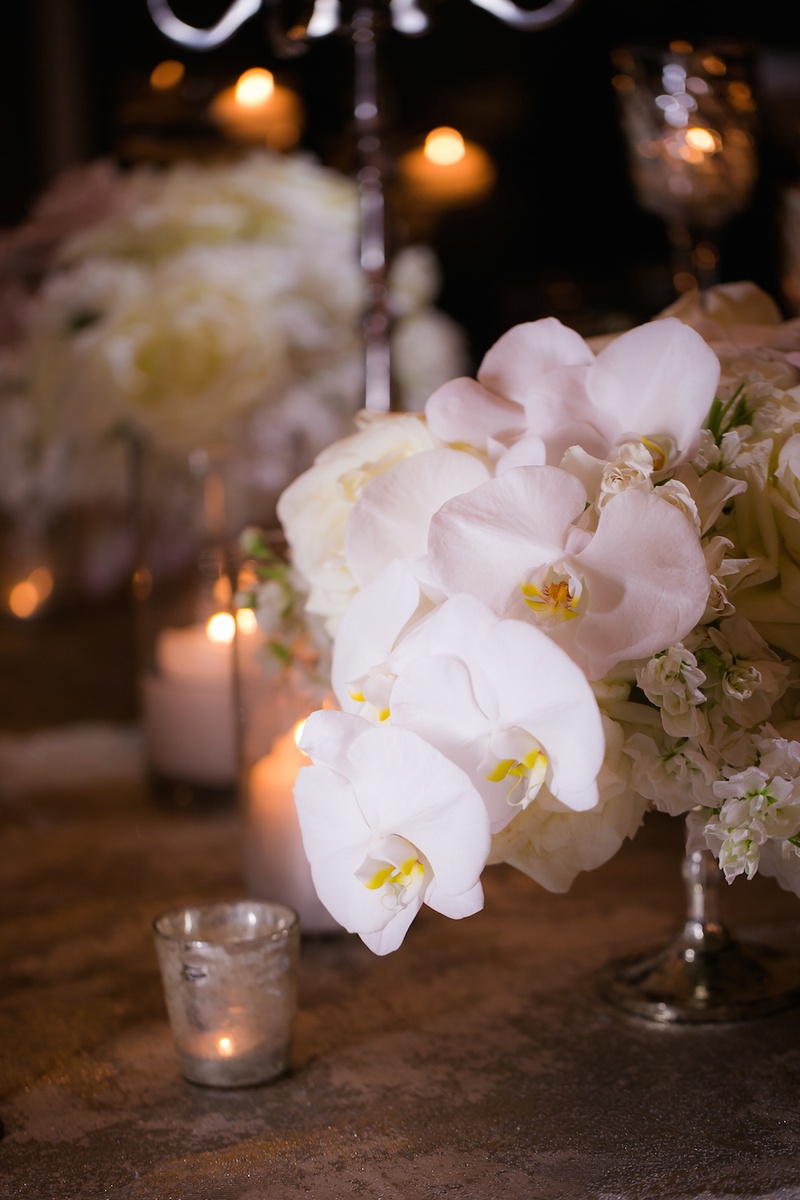 Creamy Orchids in Small Arrangement
Photography: Gold Grid Studios
Read More:
http://www.insideweddings.com/weddings/celebratory-wedding-shoot-with-elegant-romantic-decor-in-chicago/728/ Wedding reception table with white orchids, hydrangeas in a silver stand