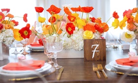 Poppy Bridal Shower Centerpiece
Photography: Melody Melikian Photography
Read More:
http://www.insideweddings.com/weddings/stylish-bridal-shower-with-pops-of-punchy-shades-lovely-florals/989/ Wood table with square wood table number orange and yellow poppy flower centerpiece bridal shower