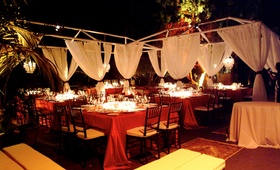Outdoor Reception Space
Photography: Kerry Kara Photography
Read More:
http://www.insideweddings.com/weddings/modern-wedding-at-james-bonds-diamonds-are-forever-location/120/ Scarlet tablecloths on tables and billowing drapery