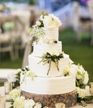 Rustic Wedding Cake Display
Photography: Catherine Hall Studios
Read More:
http://www.insideweddings.com/weddings/rustic-classic-summer-wedding-in-lake-tahoe-california/645/ White round cake on wooden slice with flowers