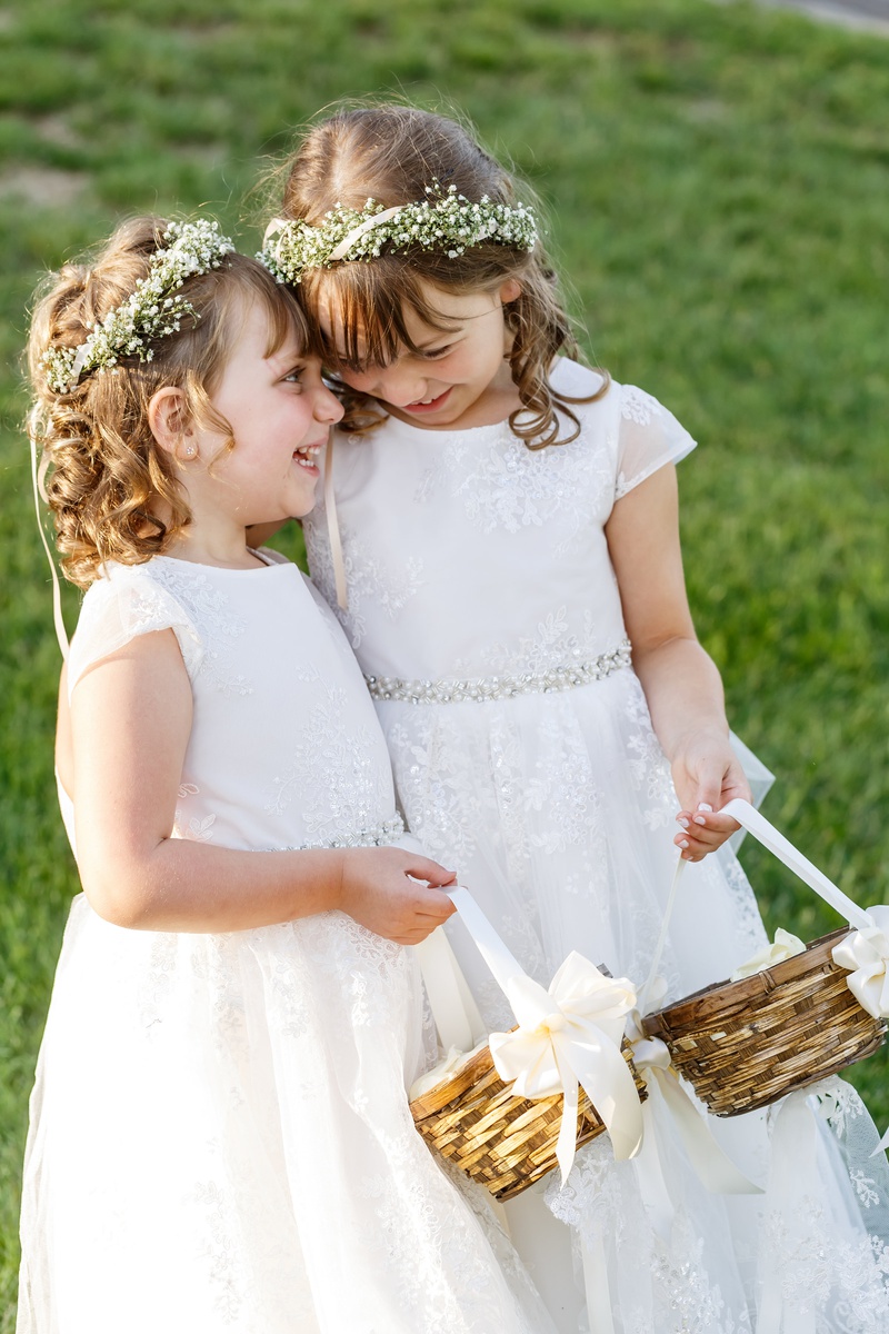 Adorable Laughing Flower Girls
Photography: Amy Anaiz Photography
Read More:
http://www.insideweddings.com/weddings/lakeside-wedding-with-blue-details-in-upstate-new-york/1140/ two flower girls with baby's breath flower crown, lace dresses, baskets, laughing together