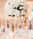 Tall White %26 Blush Reception Centerpiece
Photography: Jennefer Wilson Photography
Read More:
http://www.insideweddings.com/weddings/gorgeous-dallas-wedding-with-outdoor-ceremony-ballroom-reception/998/ Wedding reception candles floating tall glass vases with white orchid hydrangea rose greenery flower