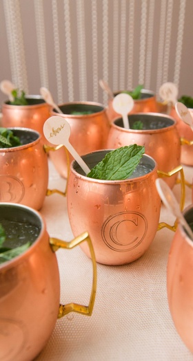 Moscow Mule Mugs with Initials
Photography: Abby Jiu Photography
Read More:
http://www.insideweddings.com/weddings/ballroom-wedding-with-classic-color-scheme-modern-catering-trends/827/ Laura Hooper Calligraphy cheers calligraphy drink stirrers in Moscow Mule copper mug with initials
