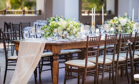 Long Wood Table with Low Centerpieces
Photography: Willa Kveta Photography
Read More:
http://www.insideweddings.com/weddings/destination-wedding-in-santa-barbara-with-california-sunshine-theme/1310/ wedding reception long wood table with wood chairs fabric runner sheer gold taper candles yellow