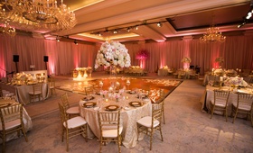 Gold Details and Pink Uplighting
Photography: Anna and Spencer Photography
Read More:
http://www.insideweddings.com/weddings/elegant-interfaith-wedding-with-a-secret-garden-theme-in-atlanta/1178/ hotel ballroom wedding with pipe and drape with pink uplighting, gold chiavari chairs, tall florals