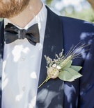 Groom's Navy Tux and Wheat Boutonniere
Photography: Willa Kveta Photography
Read More:
http://www.insideweddings.com/weddings/romantic-outdoor-bohemian-chic-wedding-at-a-santa-barbara-park/755/ close up picture of grooms navy blue tuxedo and his wheat boutonniere with green leaves wildflowers
