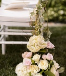 Floral Chair Decoration
Photography: Chrisman Studios
Read More:
http://www.insideweddings.com/weddings/gorgeous-alfresco-garden-wedding-in-bel-air-california/436/ White ceremony chair entwined with vines and flowers