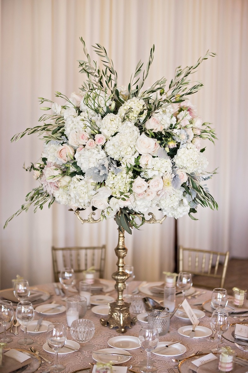 Floral Arrangement Held by Golden Candelabrum
Photography: Laurie Bailey Photography
Read More:
http://www.insideweddings.com/weddings/oceanfront-wedding-ceremony-classic-romantic-ballroom-reception/854/ gold candelabra, garden roses, hydrangea, jasmine vine, candles