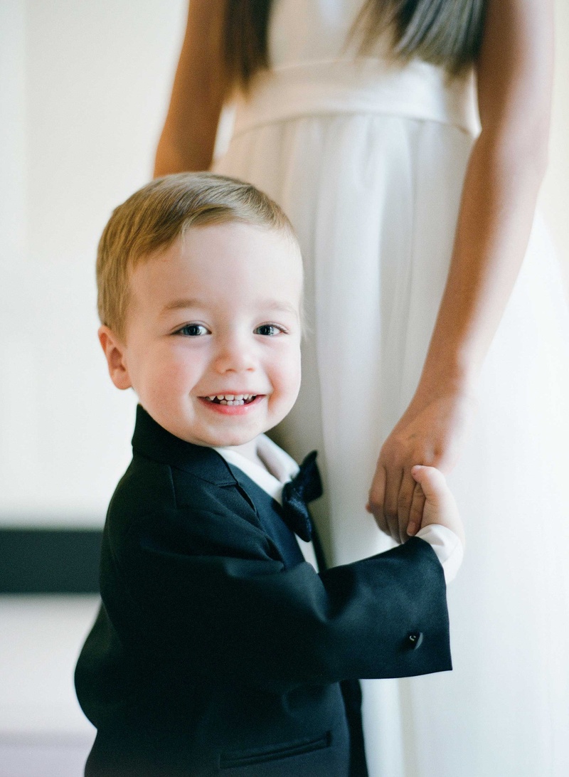 Sweet Young Ring Bearer in Bow Tie
Photography: Jose Villa Photography
Read More:
http://www.insideweddings.com/weddings/glamorous-sophisticated-garden-themed-ballroom-wedding-in-chicago/905/ Flower girl holding hand of ring bearer who smiles at camera in bow tie and suit