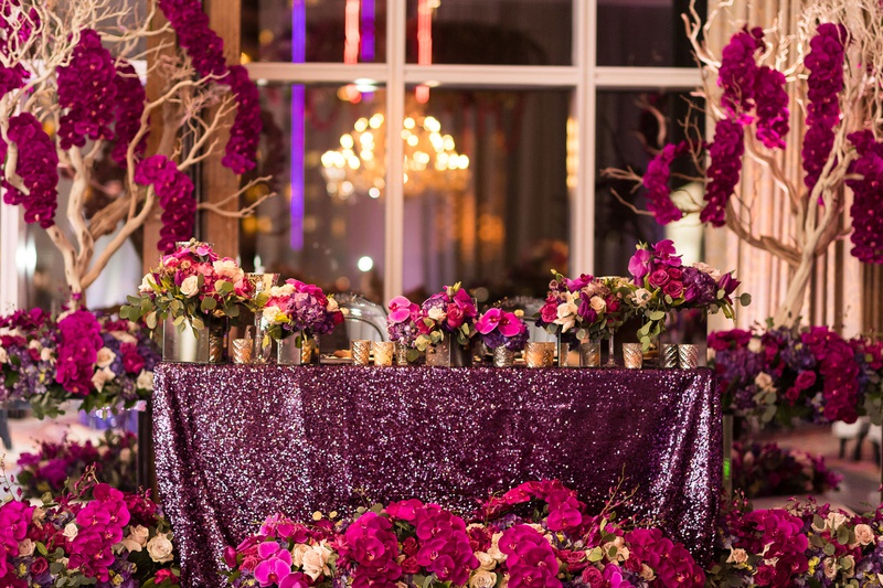 Lushly Decorated Sweetheart Table
Photography: Brian Leahy Photography
Read More:
http://www.insideweddings.com/weddings/a-hawaiian-couples-luxurious-destination-wedding-in-las-vegas/1226/ purple sequin linens, fuchsia flowers, trees with fuchsia orchids