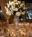 Classic Ivory Arrangement on Round Table
Photography: Carasco Photography
Read More:
http://www.insideweddings.com/weddings/rustic-chic-wedding-with-personalized-modern-details-in-chicago/1366/ tall wedding reception centerpiece white hydrangea phalaenopsis orchid rose flower glass vase candle