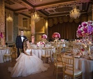 Newlyweds Pose in Reception Space