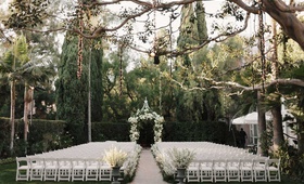 White %26 Green Outdoor Ceremony Décor
Photography: James Moes
Read More:
http://www.insideweddings.com/weddings/outdoor-fall-ceremony-luxe-ballroom-reception-in-beverly-hills/1214/ wedding ceremony white chairs urns white flowers lights hanging from tree beverly hills ceremony