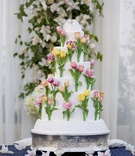 Tulip Gluten-Free Cake
Photography: Christopher Bobek, Photographer
Read More:
http://www.insideweddings.com/weddings/impressive-colorado-wedding-over-an-olympic-sized-pool/566/ Sugar flower cake with colorful tulips and bird topper
