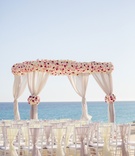 White, Blush %26 Pink Ceremony Arbor
Photography: Sara Richardson Photography
Read More:
http://www.insideweddings.com/weddings/wags-barbie-blank-hockey-player-sheldon-sourays-mexico-wedding/964/ Wedding arbor on the beach destination wedding white rose pink rose fabric on back of chairs