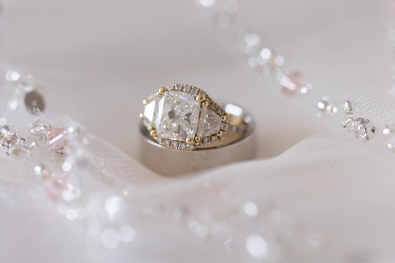 Halo Around Three-Stone Ring
Photography: Kristin Anderson
Read More:
http://www.insideweddings.com/weddings/classic-wedding-colors-with-modern-elements-in-santa-monica/1031/ radiant diamond with trapezoid side stones, yellow gold pavé halo around all three