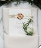 Menu with Golden Details
Photography: Lucas Rossi and Michelle Kyle
Read More:
http://www.insideweddings.com/weddings/inspirational-outdoor-garden-wedding-shoot-with-modern-elements/687/ Wedding reception menu with gold wax seal, metallic strands with white rosebud in white napkin