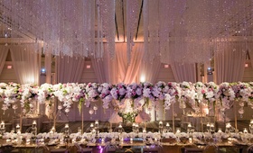"Floating" Centerpiece at Head Table
Photography: Karlisch Photography
Read More:
http://www.insideweddings.com/weddings/luxury-hotel-wedding-with-personalized-elements-in-dallas-texas/1119/ Wedding reception floating centerpiece over head table crystals on ceiling orbs candles