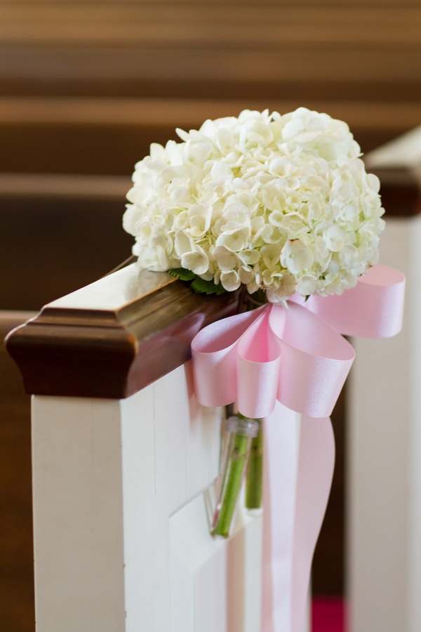 Hydrangea Pew Decoration
Photography: Aaron Watson Photography
Read More:
http://www.insideweddings.com/weddings/classic-virginia-wedding-inspired-by-grace-kellys-elegance/511/ White hydrangeas tied to church pew with pink ribbon