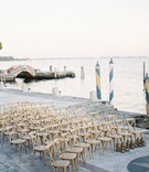 Wooden Chairs by the Water in Miami
Photography: Jacqui Cole Photography
Read More:
http://www.insideweddings.com/weddings/alfresco-ceremony-dinner-reception-at-an-elegant-villa-in-miami/1020/ Villa inspired wedding in Miami wood chairs set up on walkway by water Vizcaya in Miami