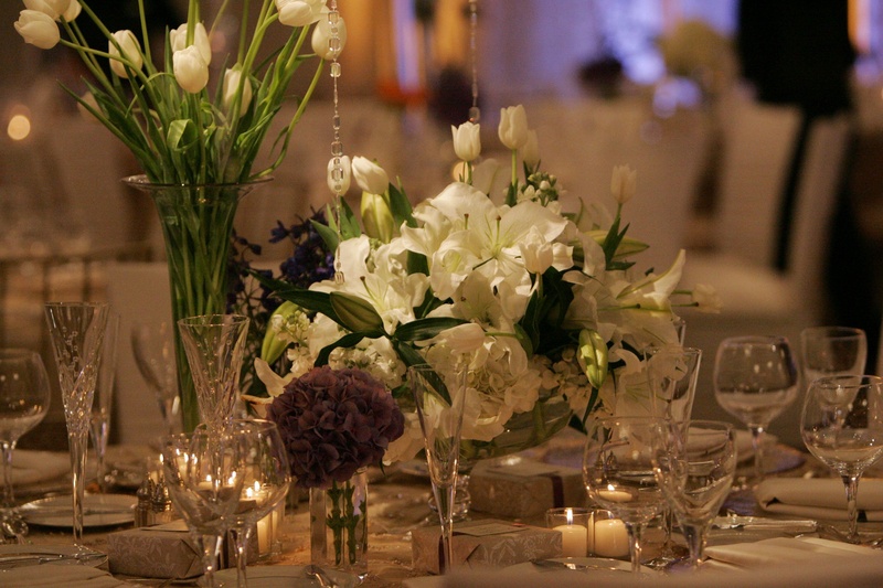 Lily and Tulip Centerpiece
Photography: Lyn Sims Photographer
Read More:
http://www.insideweddings.com/weddings/glamorous-fall-wedding-with-garden-touches-in-tucson-arizona/258/ Votive candles and low floral arrangements