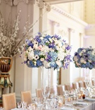 Tall Centerpiece with Blue Flowers
Photography: Larissa Cleveland Photography
Read More:
http://www.insideweddings.com/weddings/intimate-san-francisco-wedding-with-art-deco-inspired-elements/1359/ tall weddign reception centerpiece with blue, purple, pink, and white flowers