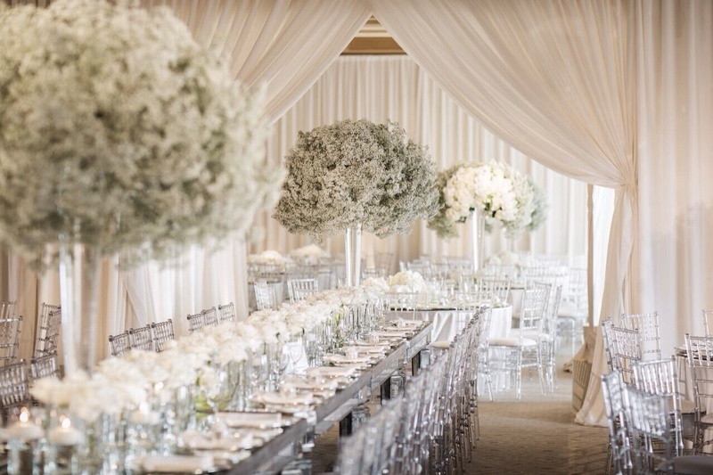 Poof Magic
Photography: Samuel Lippke
Read More:
http://www.insideweddings.com/biz/white-lilac-inc-costa-mesa/8787/ Effervescent babie's breath, lucite chairs and mirrored surfaces enforced the subtle modernity of th