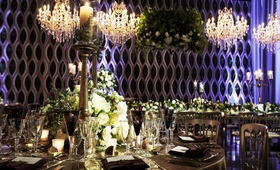 Pillar Candles Wrapped in Ferns
Photography: KingenSmith
Read More:
http://www.insideweddings.com/weddings/modern-jewish-wedding-with-unique-details-and-deep-color-palette/929/ pillar candle wrapped by fern in hurricane and brass candlestick, wedding centerpiece